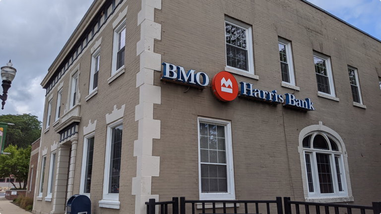 Historic-style BMO Harris Bank building with arched windows and neutral brick exterior, part of Brookline’s sale-leaseback property portfolio.