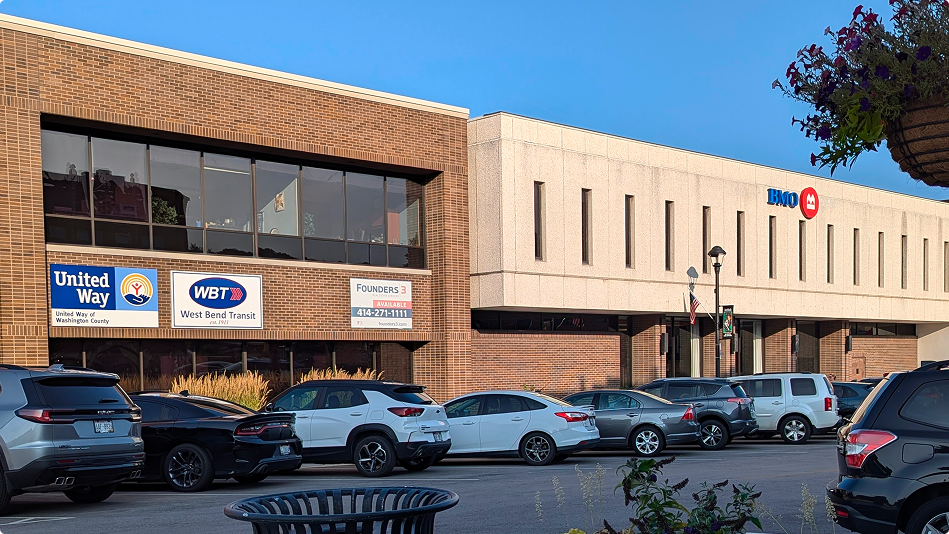 West Bend commercial building featuring BMO, United Way, and West Bend Transit signage—multi-tenant property managed through Brookline's sale-leaseback model.